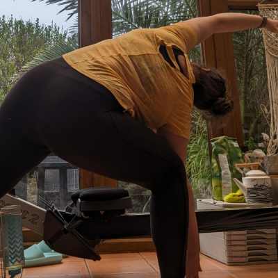 Female doing a yoga side bend stretch to the right.